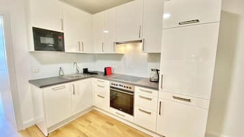 Departamento superior, 1 cama Queen size y sofá cama, para no fumadores, cocina | Cocina privada | Refrigerador con congelador, microondas y parrilla de estufa