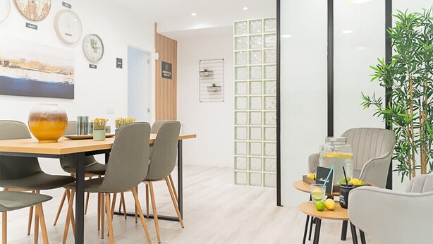 A modern dining area with a wooden table and chairs, a small side table with drinks, and a plant in the corner. - Paris: room with comfort, cosiness and shared areas Chamartín – Mauricio Legendre (Madrid)