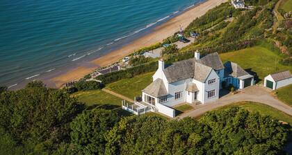 Cliff Top is a refined coastal retreat where luxury meets laid-back living. With panoramic sea views, elegant interiors, and direct access to the beach below, this is the kind of place where time slows and every detail is designed for comfort & ease.