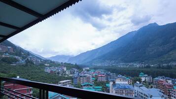 A mountainous town with buildings and a view of the valley.