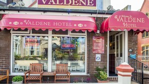 The exterior of Valdene Hotel with a prominent sign, a neon sign indicating no vacancies, and a bench outside. - Valdene Hotel (Blackpool)