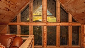 A wooden cabin with a sloped roof and large windows. - 🌲 Paradise View In The Smokies 🌅 Views, Resort Pool & Game Room (Sevierville)