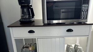A kitchen counter with a coffee maker and a microwave. - 4-bedroom house in adorable Clear Lake with AC, WiFi. Enjoy your stay (Clear Lake)