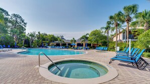A pool area with a hot tub, lounge chairs, and palm trees. - Bahama BAY Resort Near Disney! 3BR 2BA + Kitchen! (Davenport)