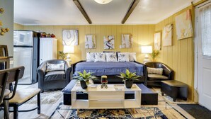 Ein modernes Schlafzimmer mit einem Bett, zwei Sofas, einem Couchtisch und einem Kühlschrank.