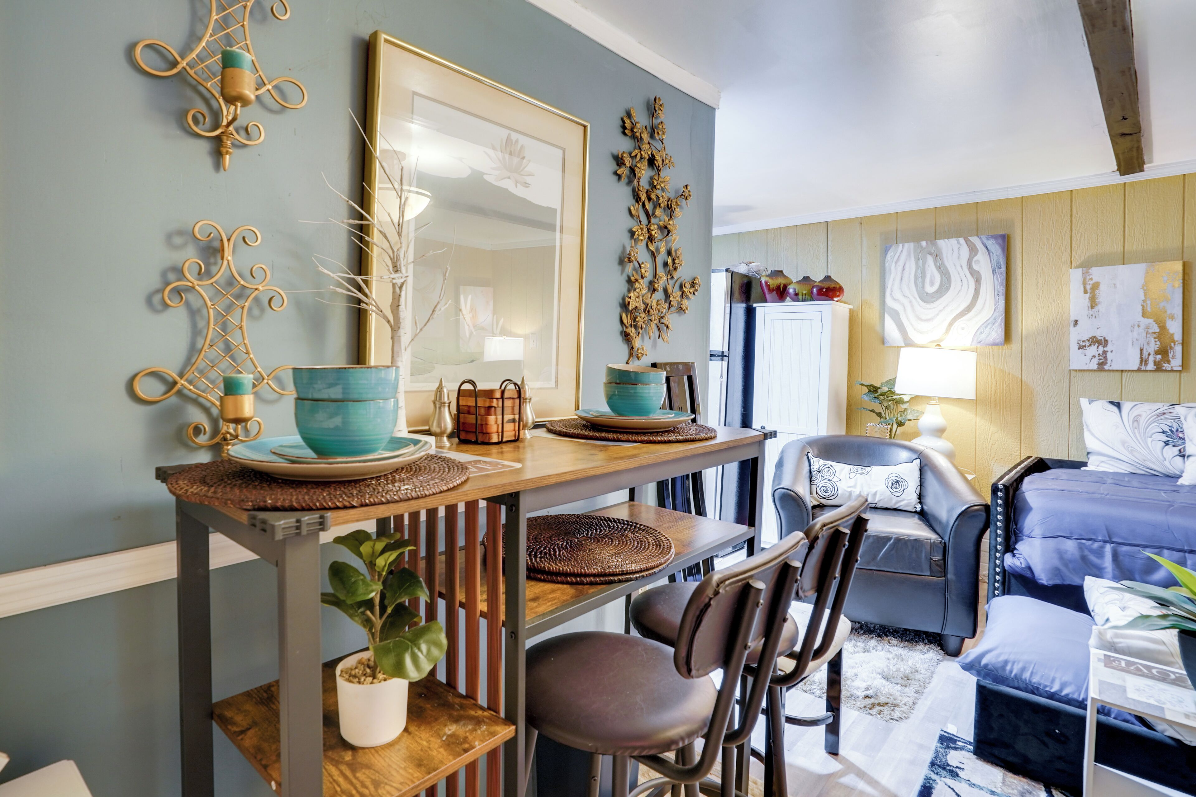 A dining area with a wooden table, chairs, and a potted plant.