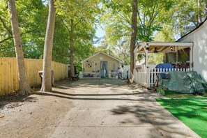 A wooden pathway leading to a small building with a star on the roof, surrounded by trees and a white picket fence. - 1 Mi to Dtwn: Fayetteville Studio w/ Patio (Fayetteville)