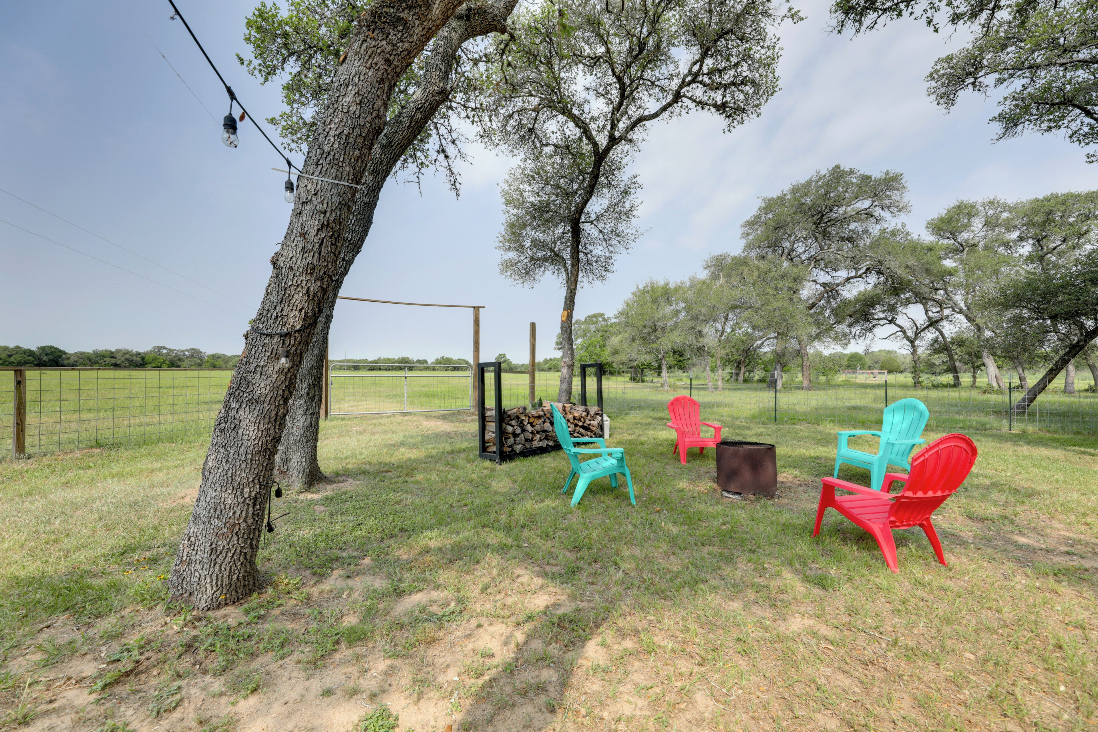 An outdoor seating area with chairs and a fire pit.