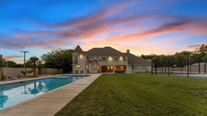 A large house with a swimming pool, a well-maintained lawn, and a fenced backyard. - The Country House: 9 Miles to Sand Hollow, HUGE Private Pool, Parking for 13! (Hurricane)