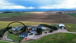 A residential area with houses, a barn, and a large field.
