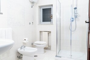 Een douche, een haardroger, een bidet, handdoeken