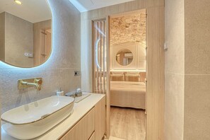 A modern bathroom with a large oval sink, a mirror, and a wooden vanity. - Central Historic Loft by Architect, Near Louvre (Paris)