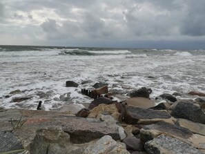 A rocky shoreline with waves crashing onto the beach.