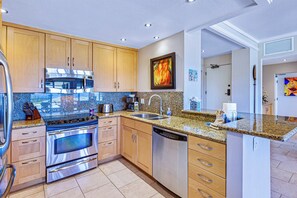 Custom cabinetry and full-size appliances throughout this gourmet kitchen.     KGV-24P2 - Kapalua Golf | Golf View 4 BR, Sleeps 12 | Car Incl. w/ 6+ Nights | KGV ML-1135 by KBM (Lahaina)
