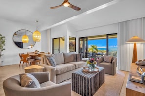Lounge in the spacious living room with soft seating and wide lanai doors bringing the outdoors in. KGV-24P7 - Kapalua Golf | Golf View 4 BR, Sleeps 12 | Car Incl. w/ 6+ Nights | KGV ML-1135 by KBM (Lahaina)