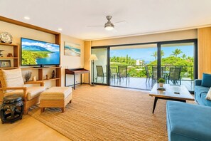 A modern living room with a television, comfortable seating, a coffee table, and a balcony with a view. - Wailea Elua Village | 2 Free Rental Cars | KBM Resorts | Panoramic Ocean Views Wailea Elua Village 2-bedroom Villa | 2 Units, 4 Bedrooms | ML-1137 (Wailea)