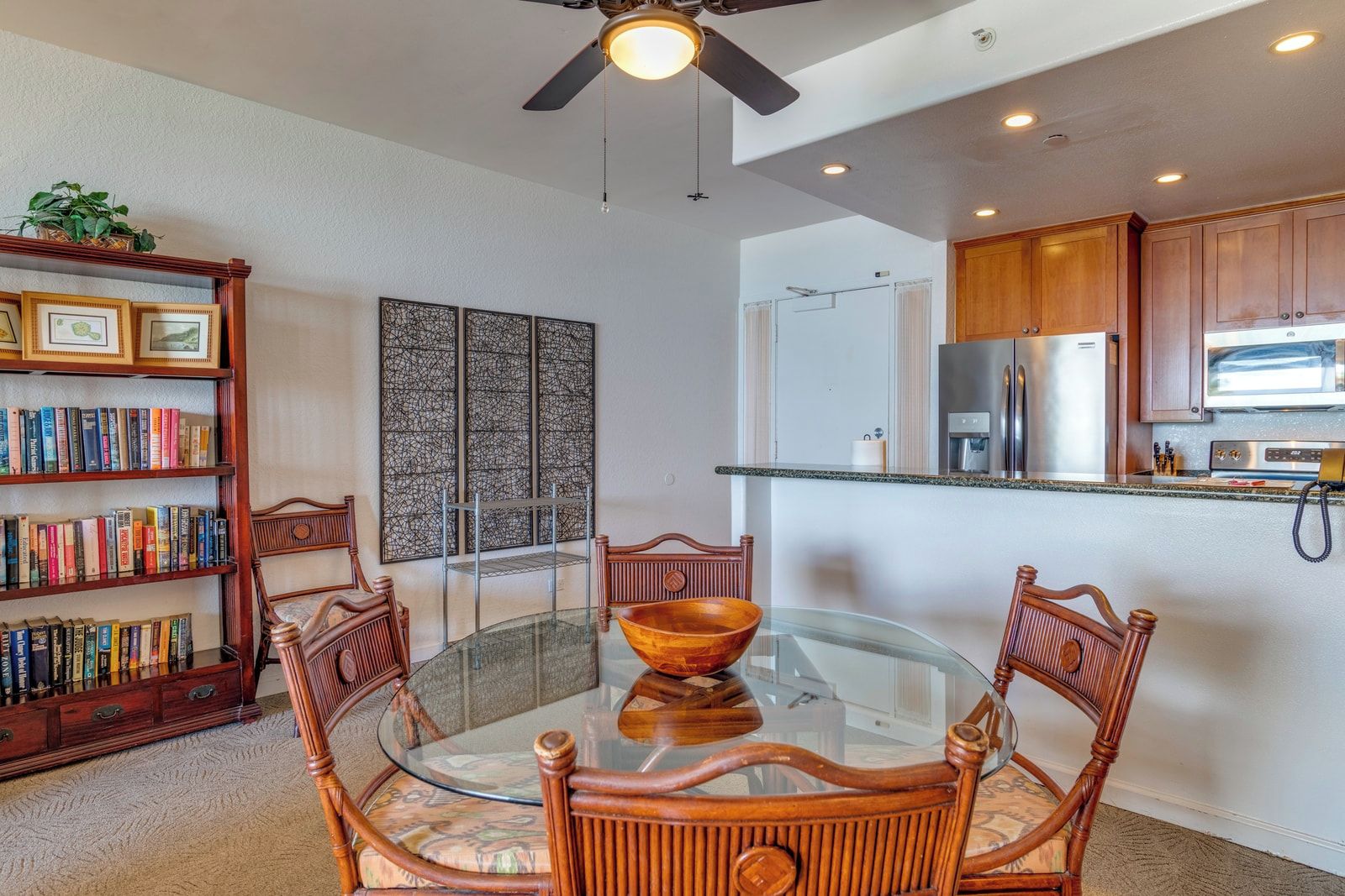  Tropical wood tones and breezy fans set the stage for cozy meals, beachy chats, and carefree island-day planning   KS-258