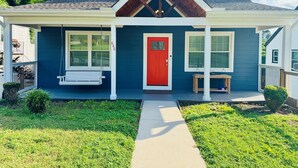 A house with a red door, a porch with a swing, and a number 646 on the wall. - NEW! 3BR/2BA home in the heart of Spartanburg SC! (Spartanburg)