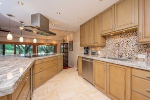 This gourmet kitchen features luxe countertops, custom cabinetry, and modern appliances—ready for any culinary adventure     KGV-14P6