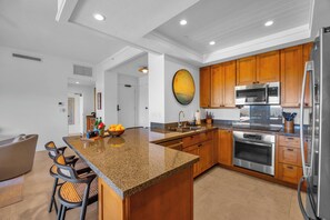 Cook with ease in a spacious kitchen featuring stainless appliances and ample counter space. KGV-24P7
