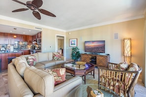 A modern living room with a sofa, coffee table, and a television. - Honua Kai | Ocean View 5 BR, Sleeps 14 | Car Incl. w/ 6+ Nights | HKH ML-1235 by KBM (Lahaina)