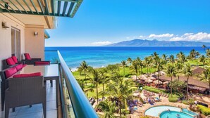 A balcony with wicker furniture and a view of the ocean and mountains. - Honua Kai | Ocean View 5 BR, Sleeps 14 | Car Incl. w/ 6+ Nights | HKH ML-1235 by KBM (Lahaina)