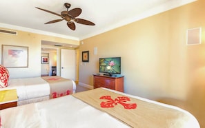 A hotel room with two beds, a ceiling fan, a television, and artwork on the walls. - Honua Kai | Ocean View 5 BR, Sleeps 14 | Car Incl. w/ 6+ Nights | HKH ML-1235 by KBM (Lahaina)