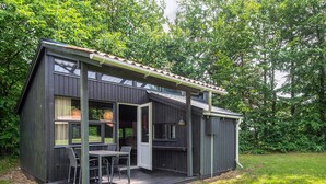 A modern house with a deck, large windows, and a door leading to an outdoor area. - 4 Person Holiday Home in Hampen (Hampen)