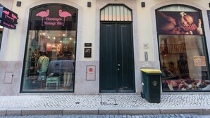 A storefront with a large arched window displaying mannequins and a sign reading "Flamingos Vintage Kitto."