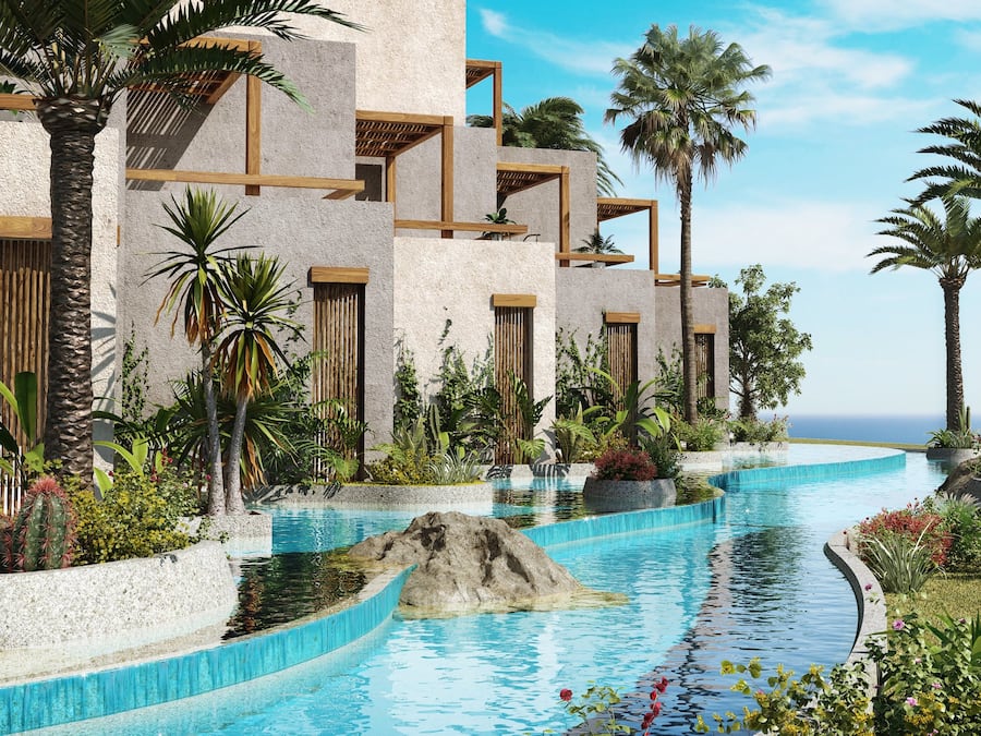 A poolside view with a curved pool, palm trees, and a building with wooden balconies.
