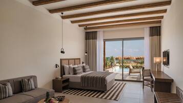 A modern hotel room with a bed, sofa, and a balcony with a pool view.