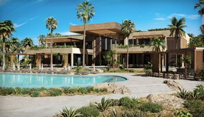 Ein Resort mit Swimmingpool, Liegebereichen und Palmen.
