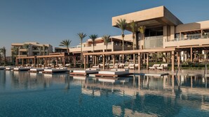 A resort with a swimming pool, lounge areas, and modern architecture.
