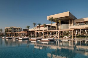 A resort with a swimming pool, lounge areas, and modern architecture.