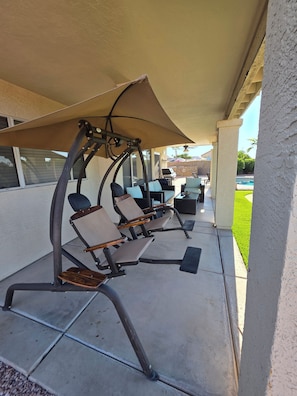 Outdoor patio seating with a canopy, a pool, and a barbecue area. - Spacious 5-bedroom house in Charming Mesa with Sparkling Heated Pool (Mesa)