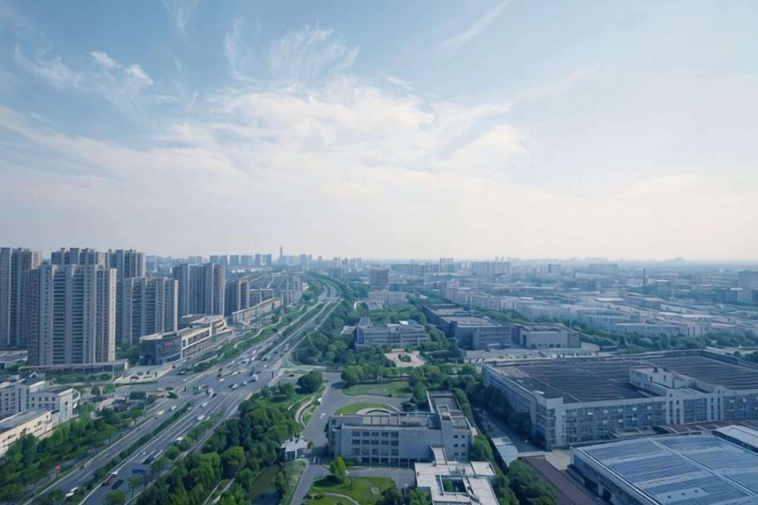 A cityscape with high-rise buildings, roads, and green spaces.