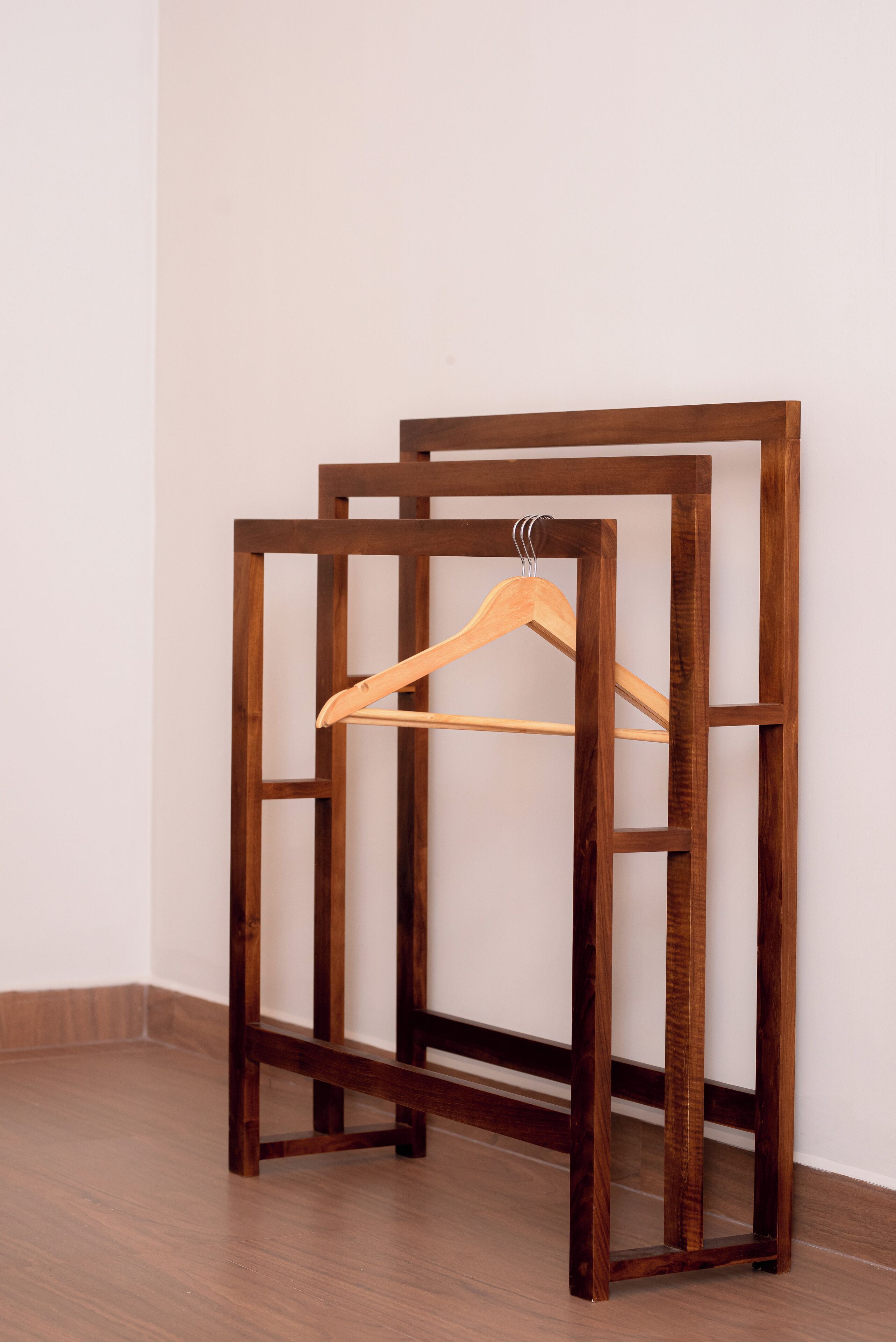 A wooden furniture piece with a hanger.