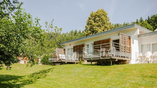 A modern two-story house with a covered patio area and a small deck. - Comfortable Apartment for Six in Alsace (Saales)
