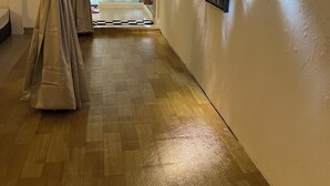 A hallway with wooden flooring, beige walls, and a ceiling light fixture. - COMFORTABLE STAY HOME (Ayer Itam)
