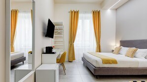 A modern hotel room with a bed, bedside table, chair, desk, and a TV mounted on the wall. - Recently renovated, within walking distance of the Vatican and 180mt from the metro. (Roma)