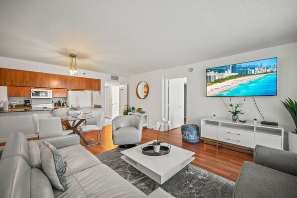 A modern living room with a sofa, coffee table, and TV.