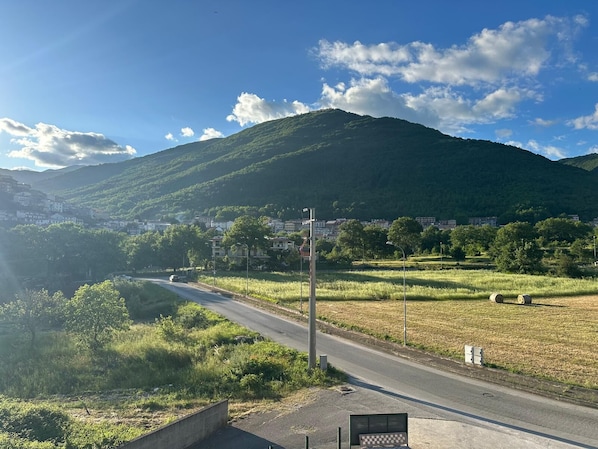 A road leading through a rural area with a mountain in the background. - Hotel Il Gabbiano (Sanza)