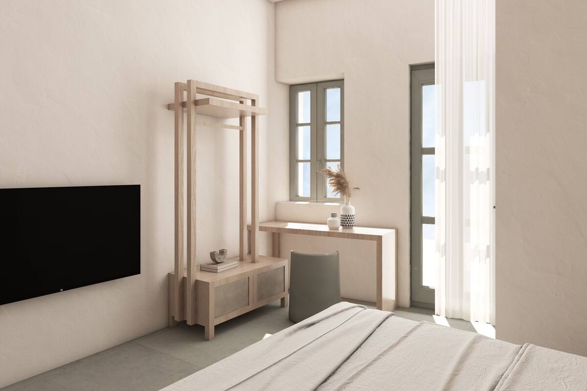 Un dormitorio moderno con una cama, un armario de madera, un escritorio con silla y un televisor montado en la pared.
