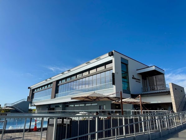 A modern building with large windows, a flat roof, and a sign that reads "LOOKOUT".