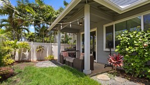 A covered porch with outdoor furniture, a grill, and string lights. - Relaxed Island Living- WD, AC, Backyard, Workspace (Ewa Beach)
