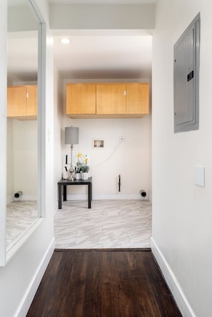 Experience the perfect blend of elegance and functionality in this beautifully designed hallway, featuring a stylish storage cabinet, a cozy reading nook, and modern electrical amenities.