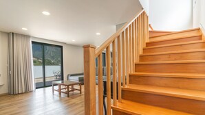 A wooden staircase leading to a balcony with a view of a mountainous landscape. - Villa Lorenzo by Atlantic Holiday (São Vicente)