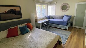 A bedroom with a bed, a desk, a chair, a ceiling fan, and a window with blinds. - Winnipesaukee Condo Walk to Beach, Pool, Near Gunstock (Gilford)