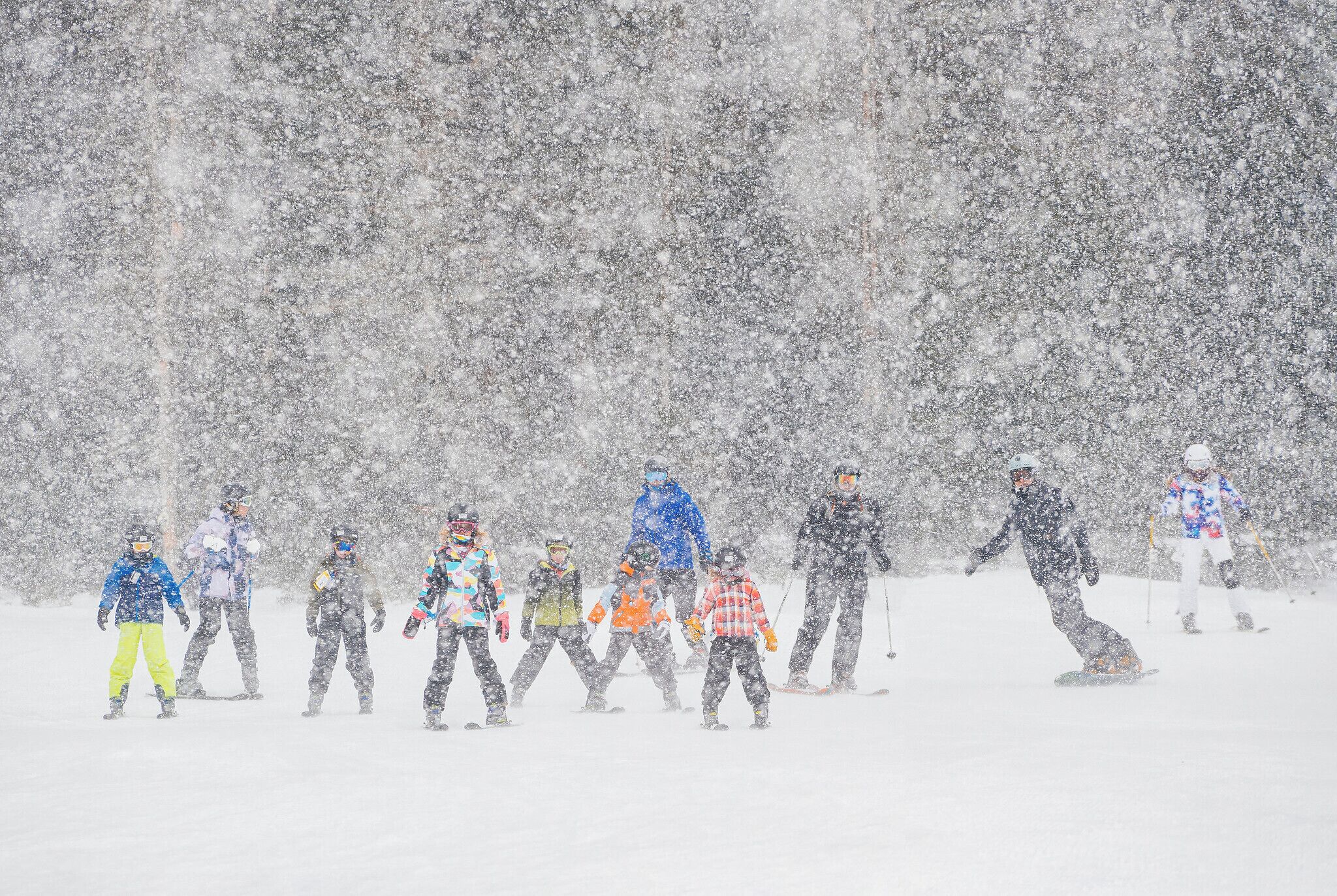 A group of people in winter clothing on a snowy slope.