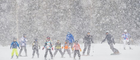 A group of people in winter clothing on a snowy slope.